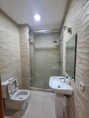 a bathroom with a toilet and a sink and a shower at Villa targa prestige in Marrakech