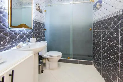 a bathroom with a toilet sink and a shower at Charming Majorelle Apartment in Marrakech