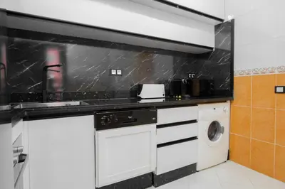 a kitchen with a washer and a washing machine at Charming Majorelle Apartment in Marrakech