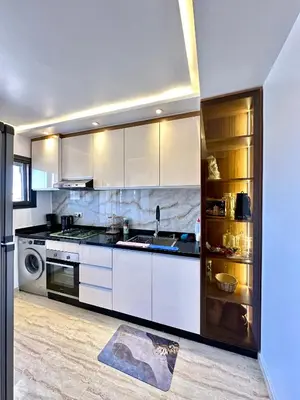 a kitchen with white cabinets and a sink at Séjournez dans un appart moderne, calme et tout équipé à Marrakech in Marrakech