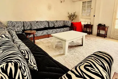 a living room with a zebra print couch and a table at Hide & seek in Marrakech