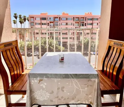 a table on a balcony with a view of a building at Hide & seek in Marrakech