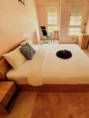 a bedroom with a large bed with white sheets and pillows at Hide & seek in Marrakech
