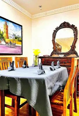 a dining room with a table and a mirror at Hide & seek in Marrakech