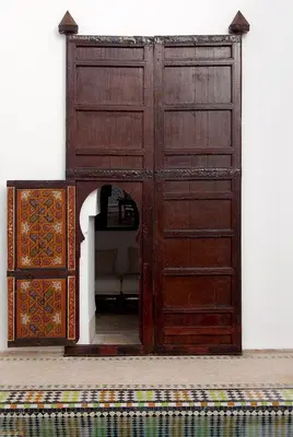 an entrance to a room with a large wooden door at Riad Porte Royale in Marrakech