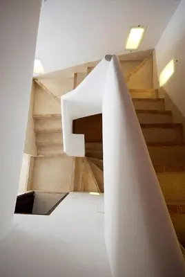 a staircase in a house with a white stair case at Riad Porte Royale in Marrakech