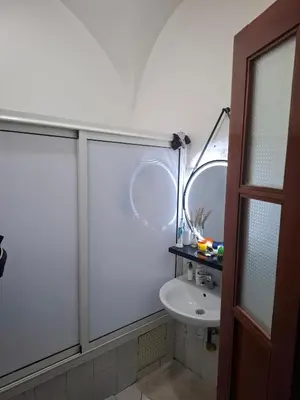 a white bathroom with a sink and a mirror at Le riad de Daba in Marrakech