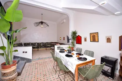 a dining room with a table and chairs at Le riad de Daba in Marrakech