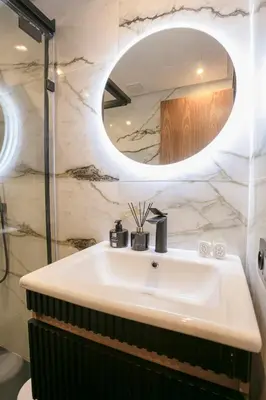 a bathroom with a sink and a mirror at Luxury Designer Apartment Central Marrakech in Marrakech
