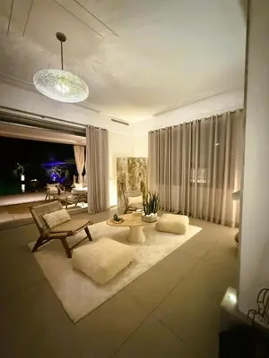 a living room with a couch and a table at Villa Marrazen, lovely villa -housestaff included in Marrakech