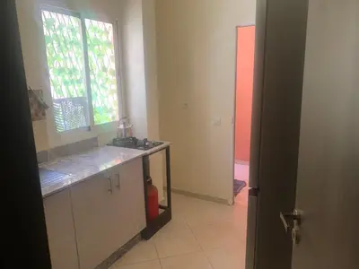 a kitchen with a counter top and a window at Appartement diar Marjane in Marrakech