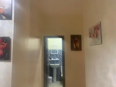 a bathroom with a mirror and a sink at Appartement diar Marjane in Marrakech