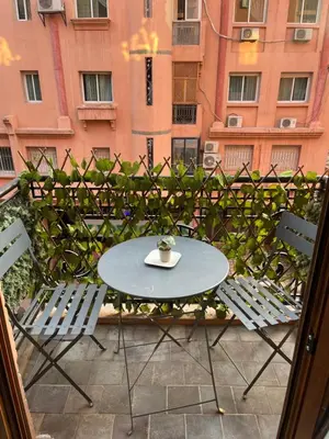 a table and chairs on a balcony with a building at GZ Loft in Marrakech