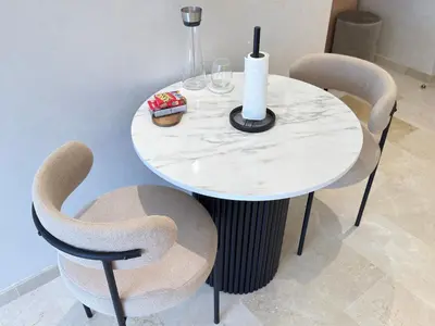 a white table with two chairs and a table with wine glasses at Modernes Apartment in Top-Lage Guéliz, Marrakech 2 in Marrakech