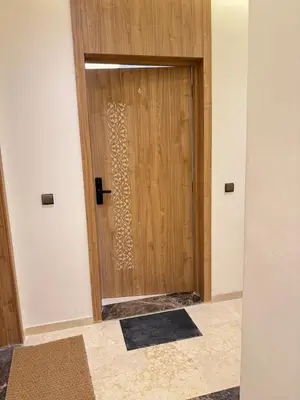 a wooden door in a room with a rug at Modernes Apartment in Top-Lage Guéliz, Marrakech 2 in Marrakech