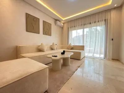 a living room with a couch and a table at Modernes Apartment in Top-Lage Guéliz, Marrakech 2 in Marrakech