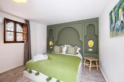 a bedroom with a large green bed in a room at Stylish and Exclusive Riad Saada with Pool and free Breakfast in Marrakech