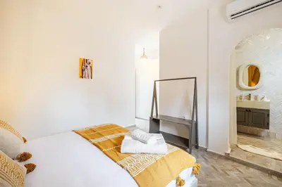 a white bedroom with a bed and a sink at Stylish and Exclusive Riad Saada with Pool and free Breakfast in Marrakech