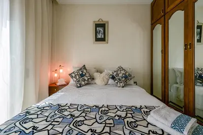 a bedroom with a bed with a blue and white comforter at Marrakech Centre Ville Rooftop & Espace Fitness in Marrakech
