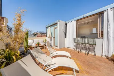 a patio with chairs and tables on a balcony at Marrakech Centre Ville Rooftop & Espace Fitness in Marrakech