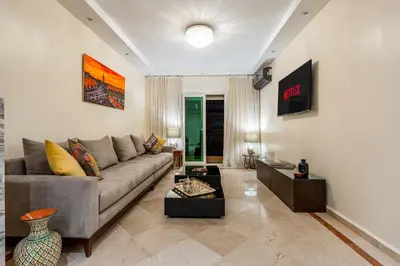 a living room with a couch and a table at Marrakech Centre Ville Rooftop & Espace Fitness in Marrakech