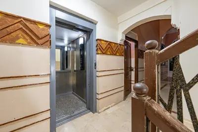 a wooden door in a hallway with a gate at Marrakech Centre Ville Rooftop & Espace Fitness in Marrakech