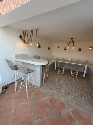 a dining room with a table and chairs in a room at Dar Farah Riad luxe privé, 3ch, piscine chauffée, ptit déj in Marrakech