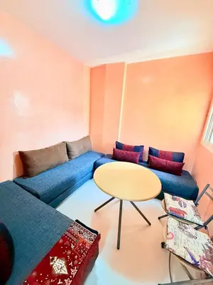 a living room with a blue couch and a table at N9 Parfait Top Près De Gueliz in Marrakech