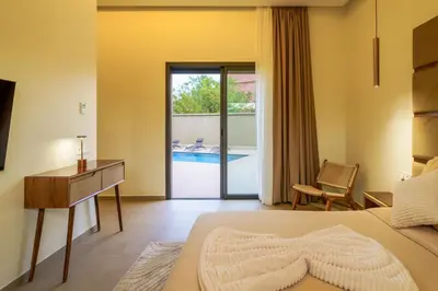 a bedroom with a bed and a desk and a pool at Villa R, luxury, gym, private pool in Marrakech