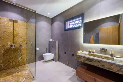 a bathroom with a shower and a toilet and a sink at Villa R, luxury, gym, private pool in Marrakech