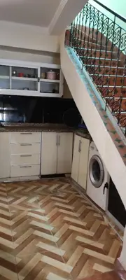 a kitchen with a staircase and a washing machine at Maison tow five in Marrakech