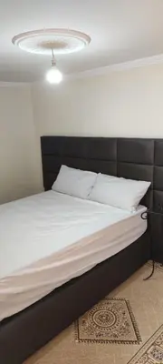 a bedroom with a large bed with a black headboard at Maison tow five in Marrakech