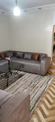 a living room with a gray couch and a rug at Maison tow five in Marrakech