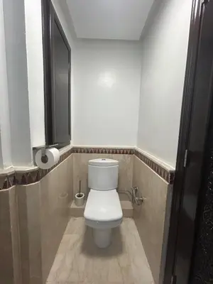 a bathroom with a white toilet and a window at Appartement neuf hivernage in Marrakech