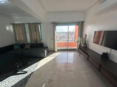 a living room with a couch and a large window at Appartement neuf hivernage in Marrakech