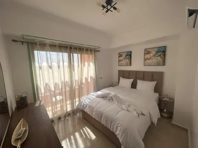 a bedroom with a large bed and a window at Appartement neuf hivernage in Marrakech