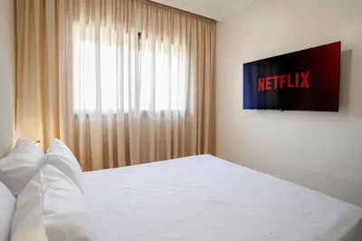 a bedroom with a white bed and a window at Âme Berbère Piscine Privée in Marrakech