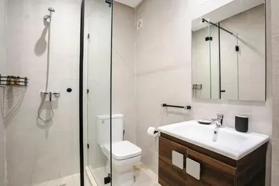 a bathroom with a shower and a toilet and a sink at Âme Berbère Piscine Privée in Marrakech