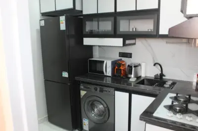 a kitchen with a refrigerator and a washing machine at Appartement mamá MK in Marrakech