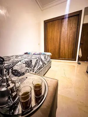 a room with a bed and two drinks on a tray at Chez Mams Guest House - Private Rooms in a Resort-Style Apartment Complex in Marrakech