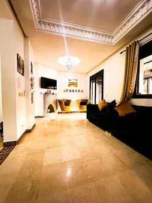 a living room with a couch and a fireplace at Chez Mams Guest House - Private Rooms in a Resort-Style Apartment Complex in Marrakech