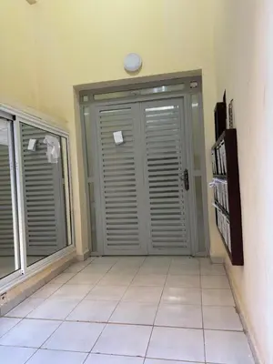 a room with a large door and a tile floor at Les jardins de Carlota in Marrakech
