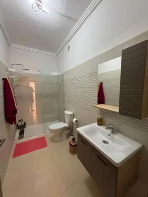 a bathroom with a sink and a toilet and a shower at Les jardins de Carlota in Marrakech