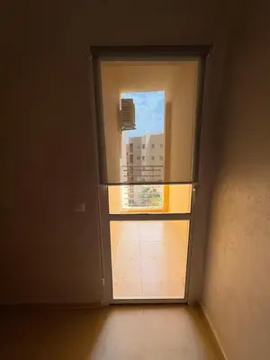 an open door with a view of a building at Les jardins de Carlota in Marrakech