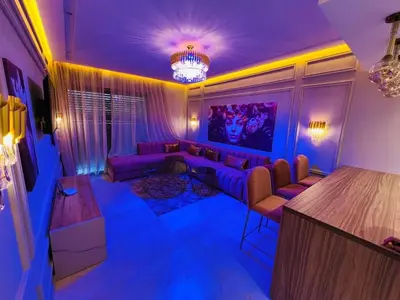 a living room with purple lighting and a couch at Perle garden in Marrakech