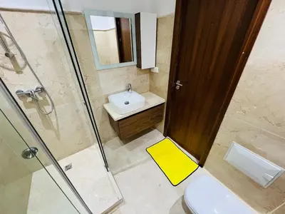 a bathroom with a toilet and a sink and a shower at Perle garden in Marrakech