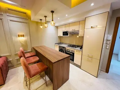 a kitchen with a wooden table and orange chairs at Perle garden in Marrakech