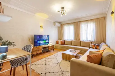 a living room with a couch and a tv at Chic & Calm in Marrakech, Ideal for Digital Nomads in Marrakech