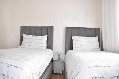 two beds sitting next to each other in a bedroom at Chic & Calm in Marrakech, Ideal for Digital Nomads in Marrakech