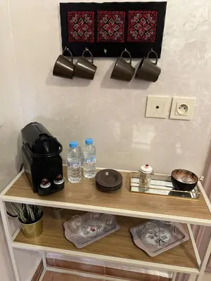 a shelf with plates and water bottles on it at Chic & Calm in Marrakech, Ideal for Digital Nomads in Marrakech